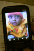 Humaun shows us a photo of his baby child on his phone