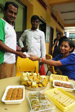 Nasreen Ramnath gave out boxes and boxes of traditional sweets at Diwali (Deepavali) 2015. Here her daughter Aisha is giving a portion to a worker.